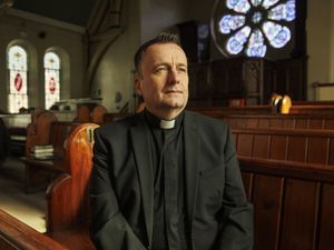 Father Tim Bartlett inside a church