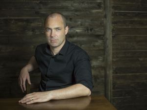 Donal Ryan sitting on a chair in a black shirt