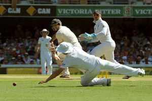 Australia's Mitchell Johnson (centre)hits a shot past England's Jonathan Trott (foreground)