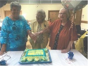 Past chairs cutting the 20th anniversary cake. Photo: Welshpool and District u3a