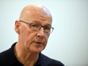 John Swinney wearing a black shirt