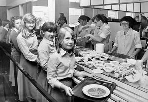 'Children queue for their new-style lunch at Wrockwardine Wood School today' reads the caption on the back of this print taken on 2 September 1980. The accompanying story explained that a new school cafeteria system had started, one of five being tried throughout Shropshire.