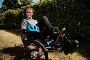 Chris Flood, 23, with his crowd-funded electrically assisted tricycle