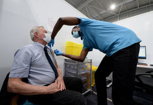 Neil Burgess from Willenhall, gets the jab from assistant practitioner Opeyemi Ajulo