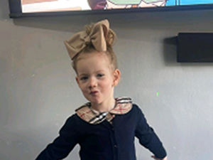 Handout photo of Mayci Fox posing for a photo with a large bow in her hair