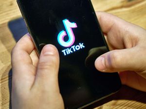 TikTok app on the smartphone screen in a child's hands