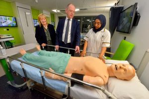 Dr Alex Hopkins and vice-chancellor Geoff Layer with student Fuzia Bi on a mock hospital ward