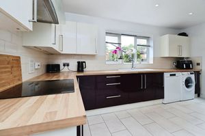 The kitchen has ample storage and integrated appliances