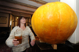 Licensee Tracey Hilton hosts a guess the weight of a locally grown giant pumpkin competition at The Robin Hood, Willenhall, 2015.