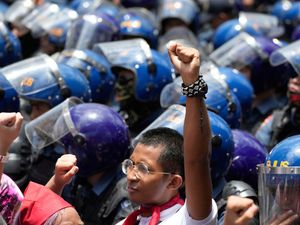 A protester holding up one fist in a May Day rally in the Philippines