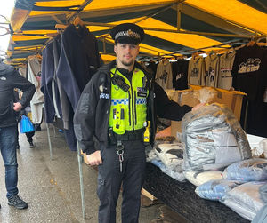Police officer at Bescott Market, Walsall, where three stalls were found selling counterfeit goods