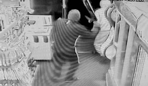 Mr Bangar chases off the defendants with a cricket bat