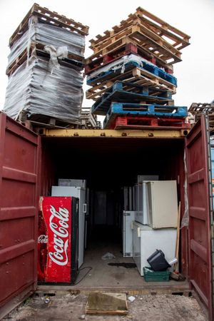 Stacked pallets and discarded fridges and freezers