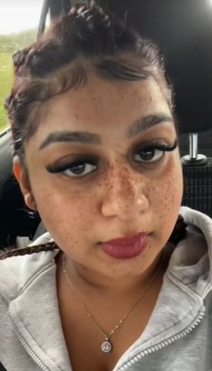 Anjali was wearing a black shirt, white high-top trainers with a pink bag and has henna drawings on her hands