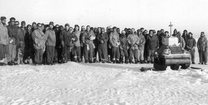 Members of the British Antarctic Survey team gather at the memorial to their three colleagues.