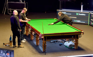 Members of the crew work to get the tables ready for the action