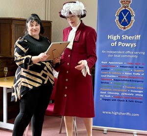 Tracy Lewis receives her certificate from Powys High Sheriff Kathryn Silk