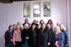 Members of Ellesmere College Parents Society, as well as Catherine Wignall, Anne Wignall and Ellesmere College Headmaster Vicky Pritt Roberts with the stained glass window created in memory of Brendan Wignall.