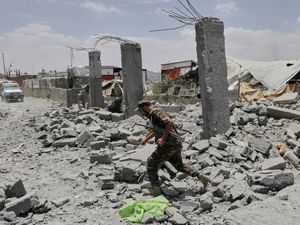 A Yemeni soldier inspects the damage reportedly caused by US air strikes in Sanaa