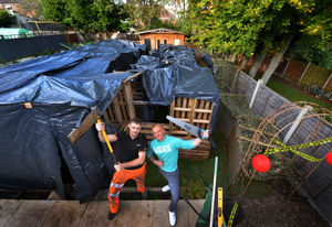 With the giant Halloween maze he built in his back garden, (left) Michael Marsden with friend Ryan Vickers, who will be helping to scare party guests on the night