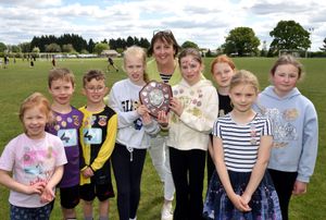 Linda Grocott presents a shield to the winners of the multi-sports challenge