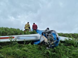 Supporting image for story: Glider occupants have lucky escape after it crashes and overturns on hill