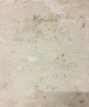 Names and numbers of servicemen drawn on the wall at the Cross Mill