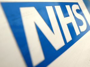 A close-up image of the NHS logo.