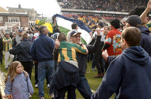 Fans spill onto the pitch after the win