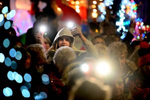 People held up their phones during carols.