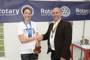 The fastest female finisher Kelly Butler is congratulated by Richard Holland President of Lichfield St Chad Rotary.