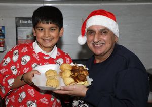 Palvinder Singh with his grandson Jasraaj holding Festive Chippy Treats Batterd Mince Pies, Festive Chips and Batterd Pings in Blankets. 