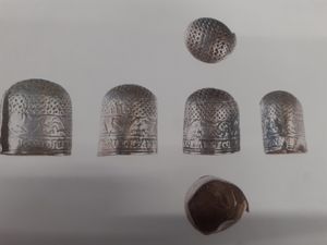 Supporting image for story: Tiny medieval silver thimble found on Shropshire farmer’s field could land metal detectorist and farmer thousands