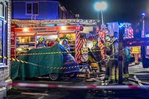 A car parked outside was also covered over as firefighters put out the blaze. Photo: SnapperSK