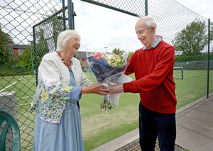 Norah Glass was presented with flowers by chairman Dan Price