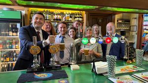 Shaun Davies MP pouring a pint at ‘Strangers’ Bar along with Steve and the team at Rowton Brewery.