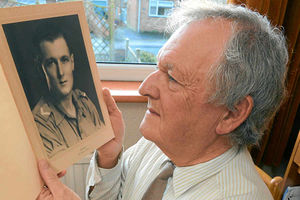 Mr Sadler takes a look at a picture of his father.