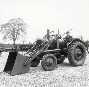 1948: employee John Wheeldon at the wheel of one of the company's early products, the Major Loader