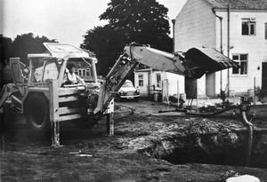 Pat Phoenix at the controls of a backhoe loader