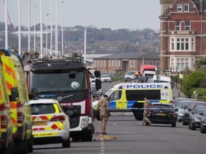 Emergency services vehicles parked along a road