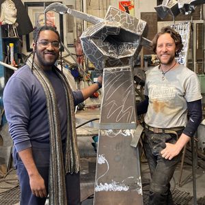 Giovanni Uche and Luke Perry with one of the statues. Photo: Asylum Art Gallery