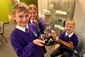 The school is proud to have earned several trophies. From left to right: Henry Dickens-Paice, Ellie Evans, and Benj Foster.
