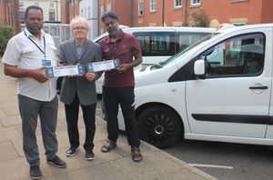 Councillor Brian Yeates issues new plates to Jilkodar Ali (left) and Azizur Rahman (right), both of whom drive wheelchair accessible hackney carriages. 