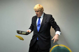 Boris Johnson attempts pancake flipping in a visit to ThePremier Suite in Cannock