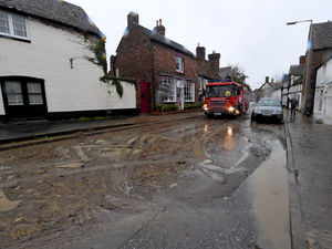 Supporting image for story: Townsfolk muck in to clear Much Wenlock's flooded roads with thick mud left behind