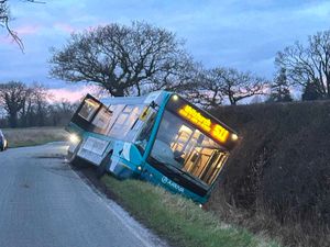 Supporting image for story: Driver and passengers 'OK' after bus ends up on its side in ditch near Wem