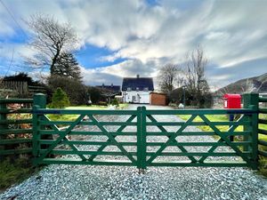 The house is approached to the rear