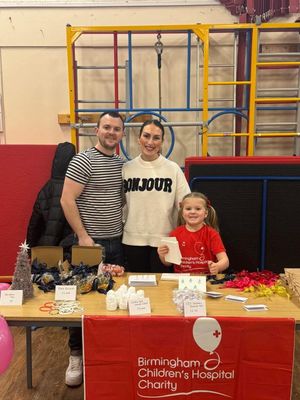 L-R: Tom (dad), Holly (mum) and Lottie at a craft sale at Lottie's school