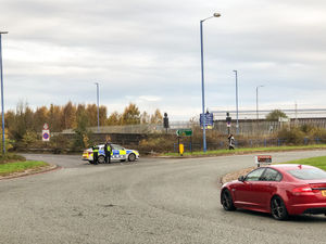 Police close the Black Country New Road off at the Patent Shaft island in the aftermath of the crash