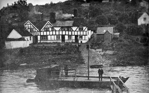The ferry over the River Severn at Jackfield. This picture is a postcard franked at Ironbridge on July 6, 1909. This was just a fortnight after the opening of the new Free Bridge over the Severn at this point - it opened on June 26, 1909. It was addressed to Capt. A. Fa (rest of name obscured by stamp), 4 Bentley Street, Stamford, Lincs. The message was: 'I.B., July 6, 09. Mrs Skitt says she no longer goes over by boat, but by the new bridge. My Dear Ada, after writing the other P.C. (views of I.B.) the P-man brought your loving P.C. 3.15. Mrs S has just told me about your P.C & has given me this to send you dear, she will write you soon. They haven't widened the river, but built a new bridge near the boat. Yours etc Tom' Ferries. Boats. Jackfield ferry. Ironbridge ferry. The black and white building is the Dog and Duck pub. This picture is from the collection of Bridgnorth postcard collector Ray Farlow. 